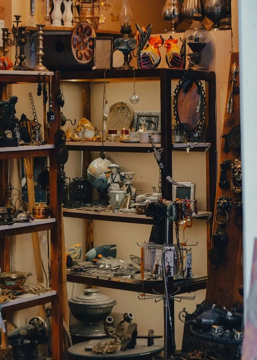 Explore a vintage antique shop with shelves full of nostalgic items and retro collectibles.